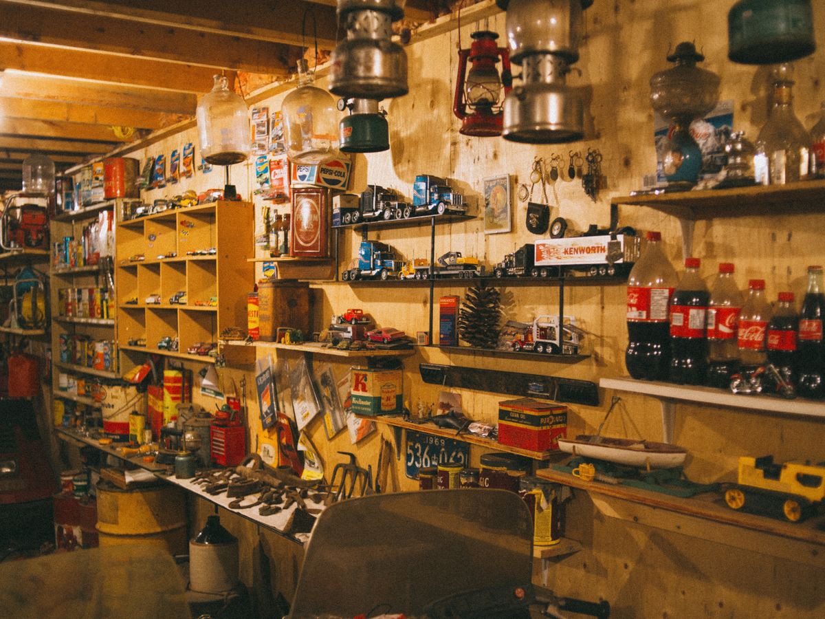A cluttered workshop with shelving and stored equipment