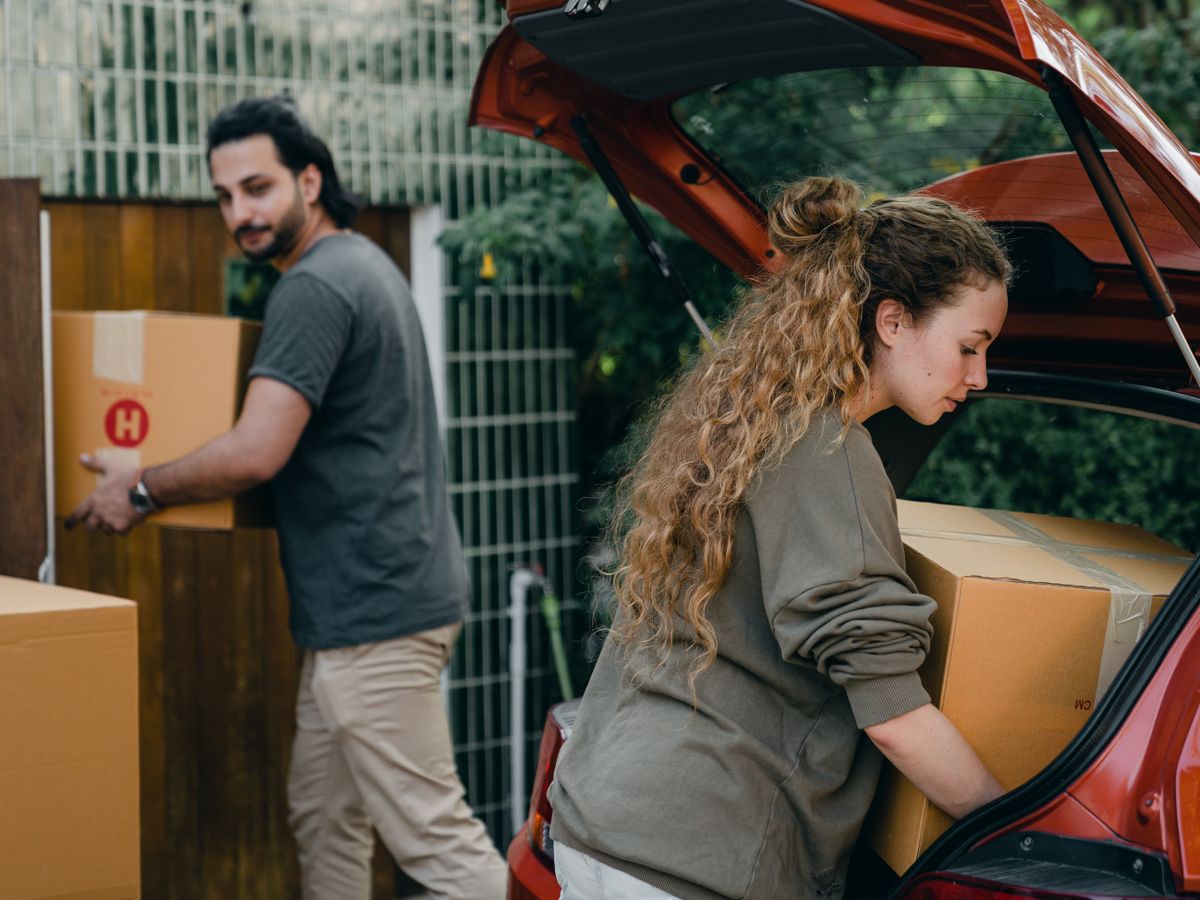 Two people loading boxes for removal